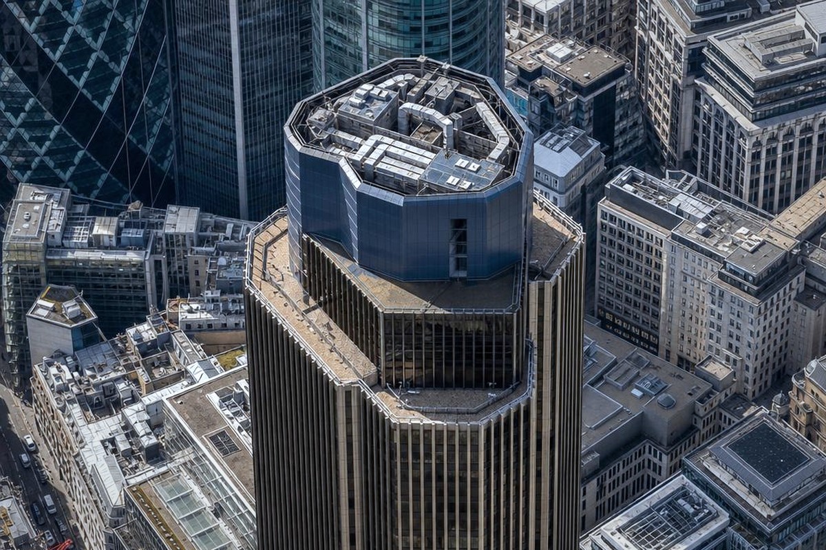 Tower 42 skyscraper in the City of London seen from above with the rooftop and surrounding buildings visible